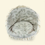 Load image into Gallery viewer, Round wicker pet bed with leaf pattern on a beige background
