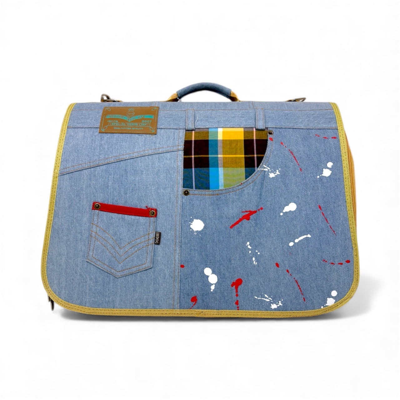 Denim-style bag with paint splatter design and plaid lining on a white background