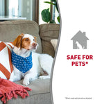 Load image into Gallery viewer, A white and brown dog wearing a blue bandana with white paw prints sits on a gray couch in a living room. The right side of the image has a white panel with a gray house icon containing a dog silhouette and the text 'SAFE FOR PETS*' in red, with small text at the bottom reading '*When used and stored as directed'.
